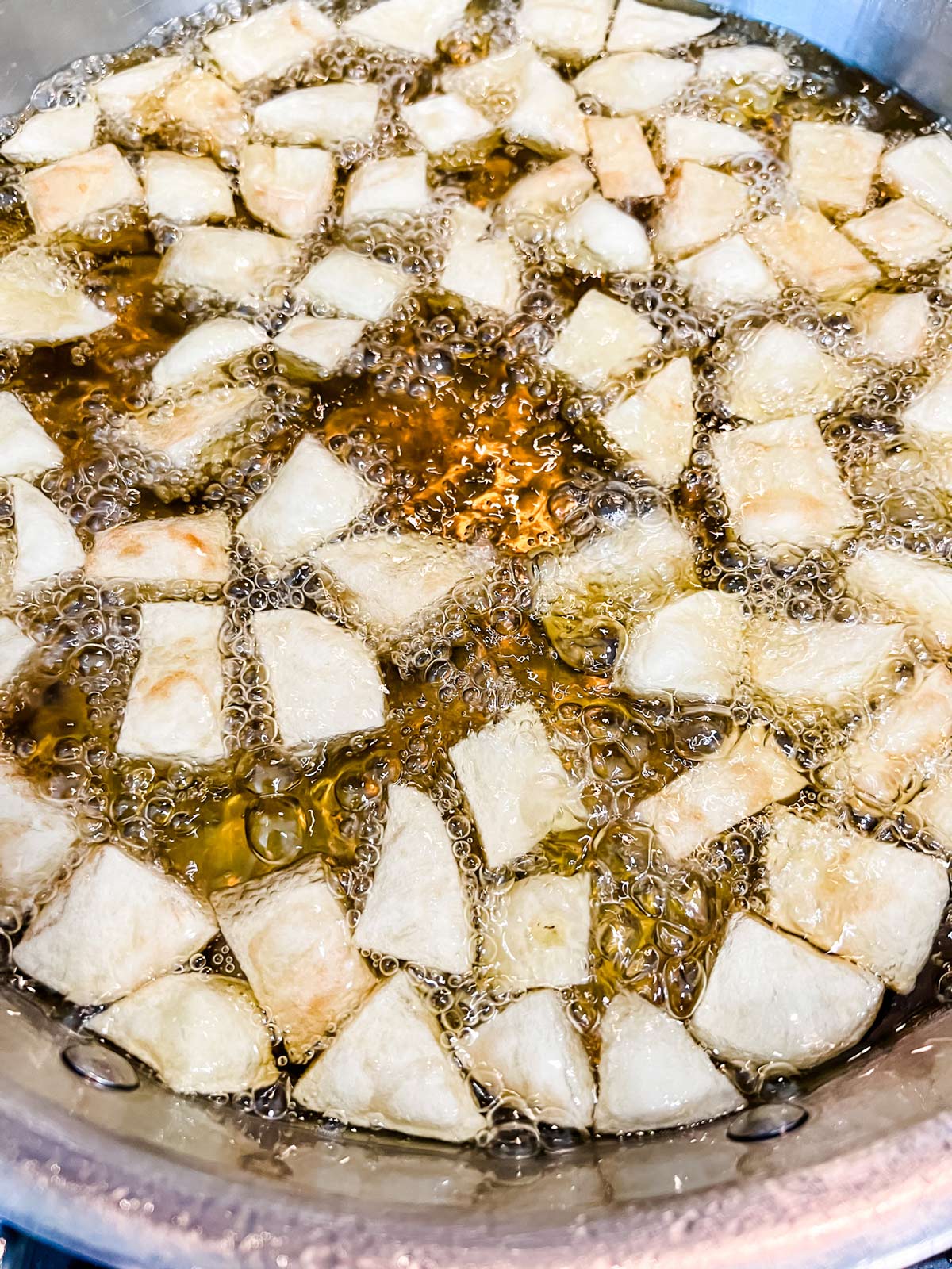 Diced potatoes frying in a skillet.