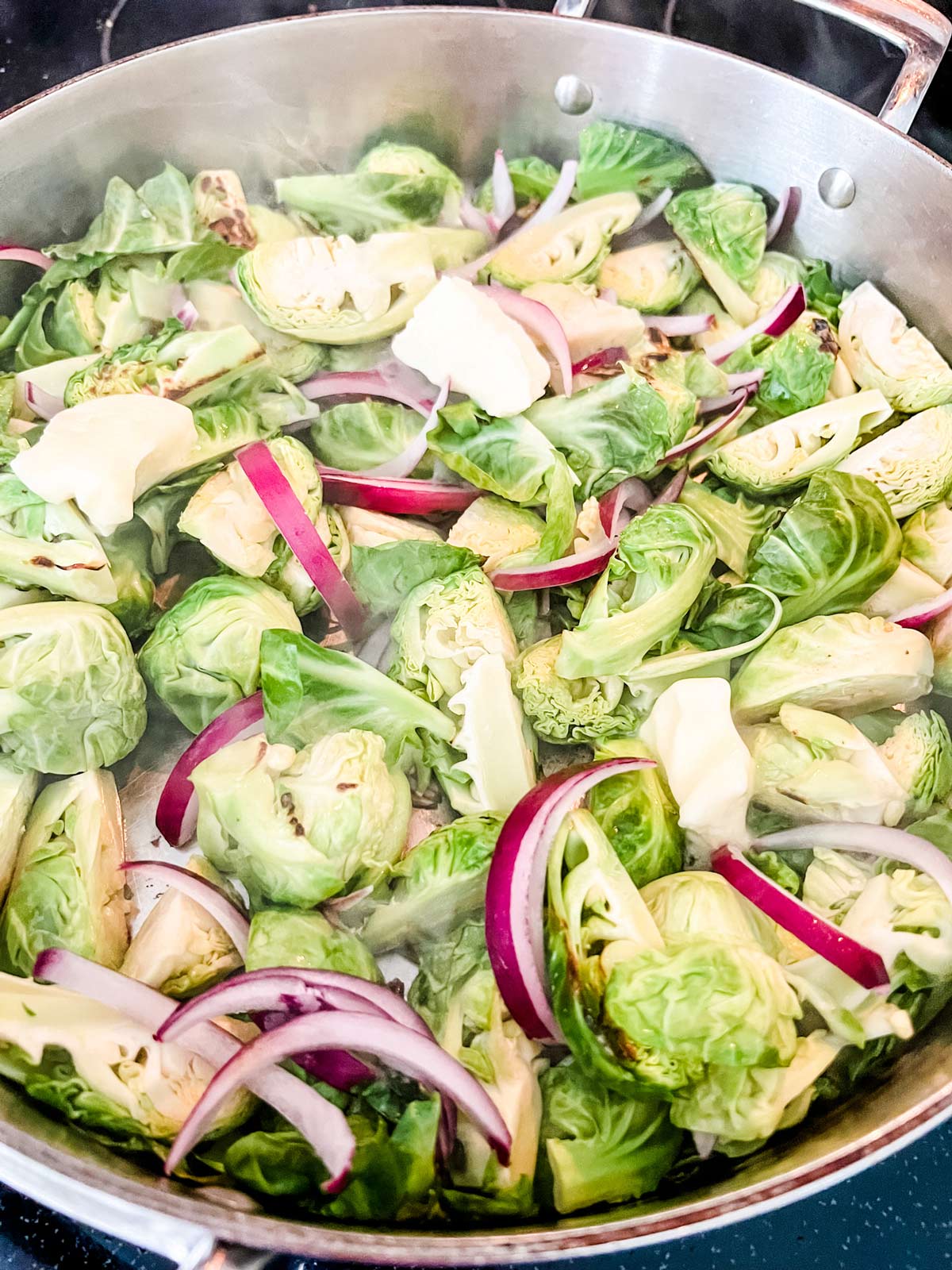 Brussels Sprouts and onion in a large skillet.