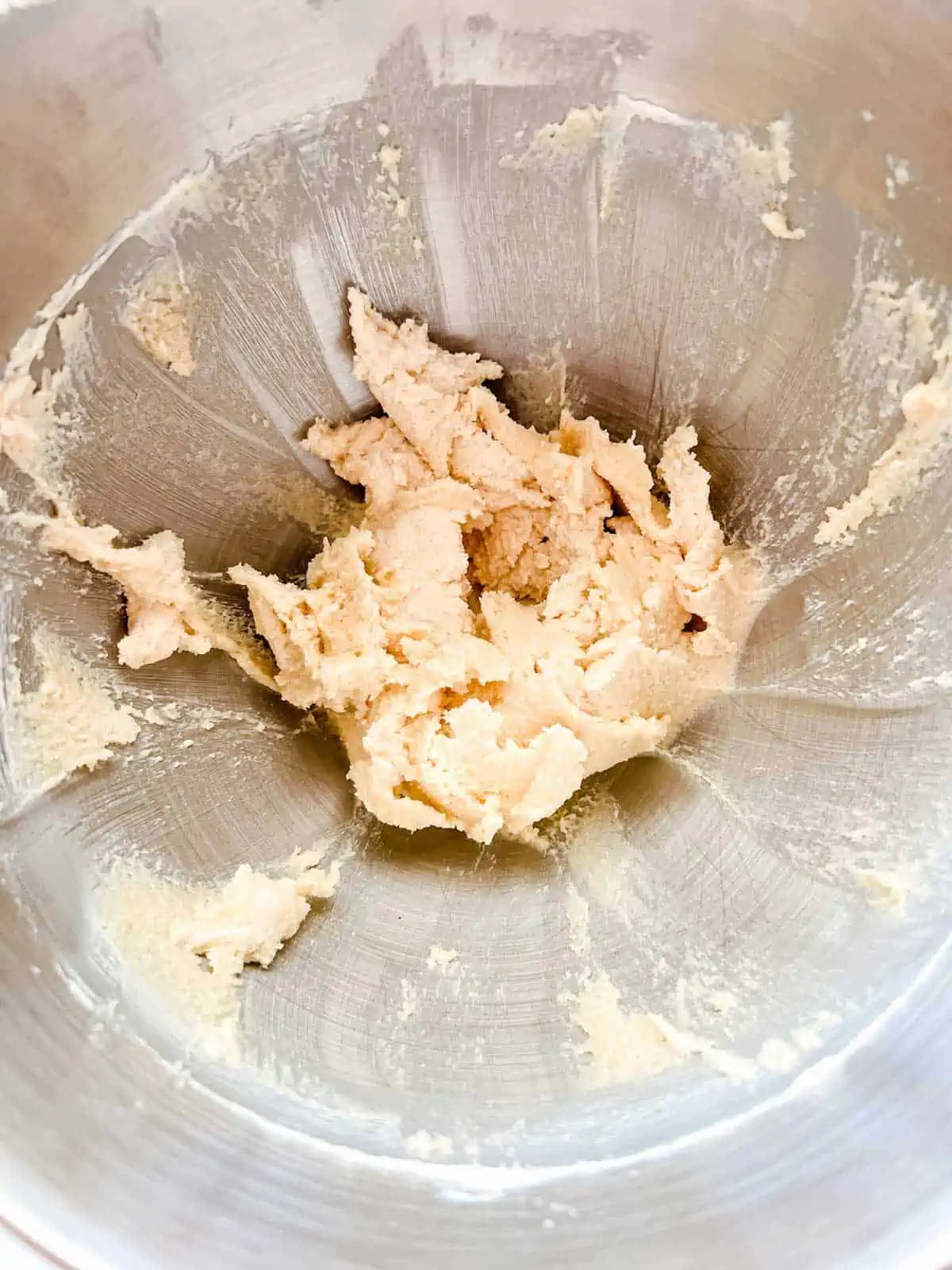 Photo of creamed butter and sugar in the bowl of stand mixer.