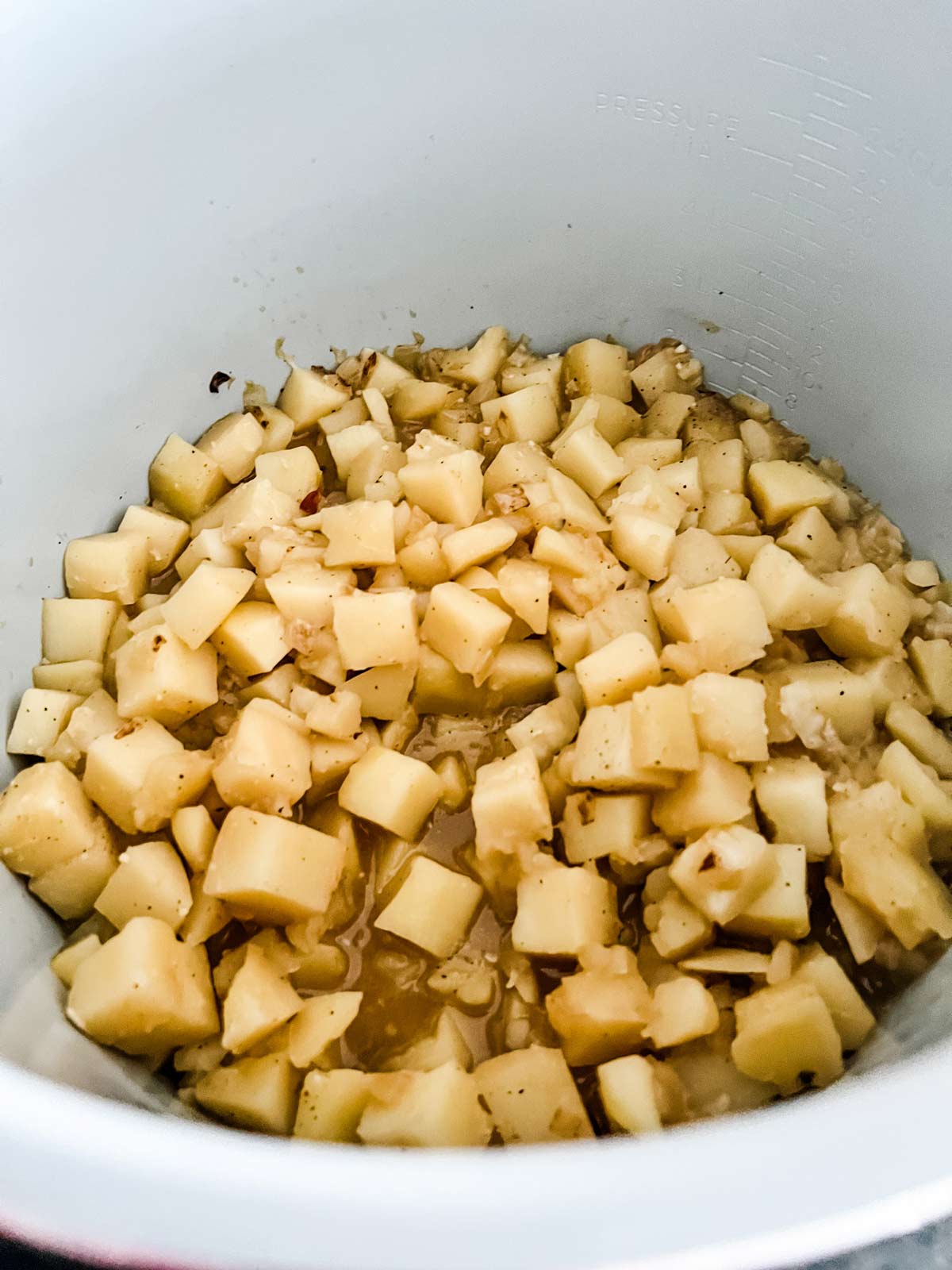 Cooked cubed potatoes in a Ninja Foodi.