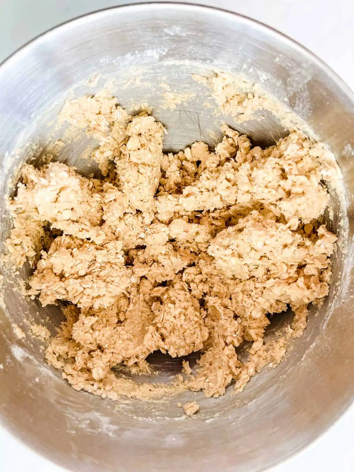 Photo of cookie dough in the bowl of a stand mixer.