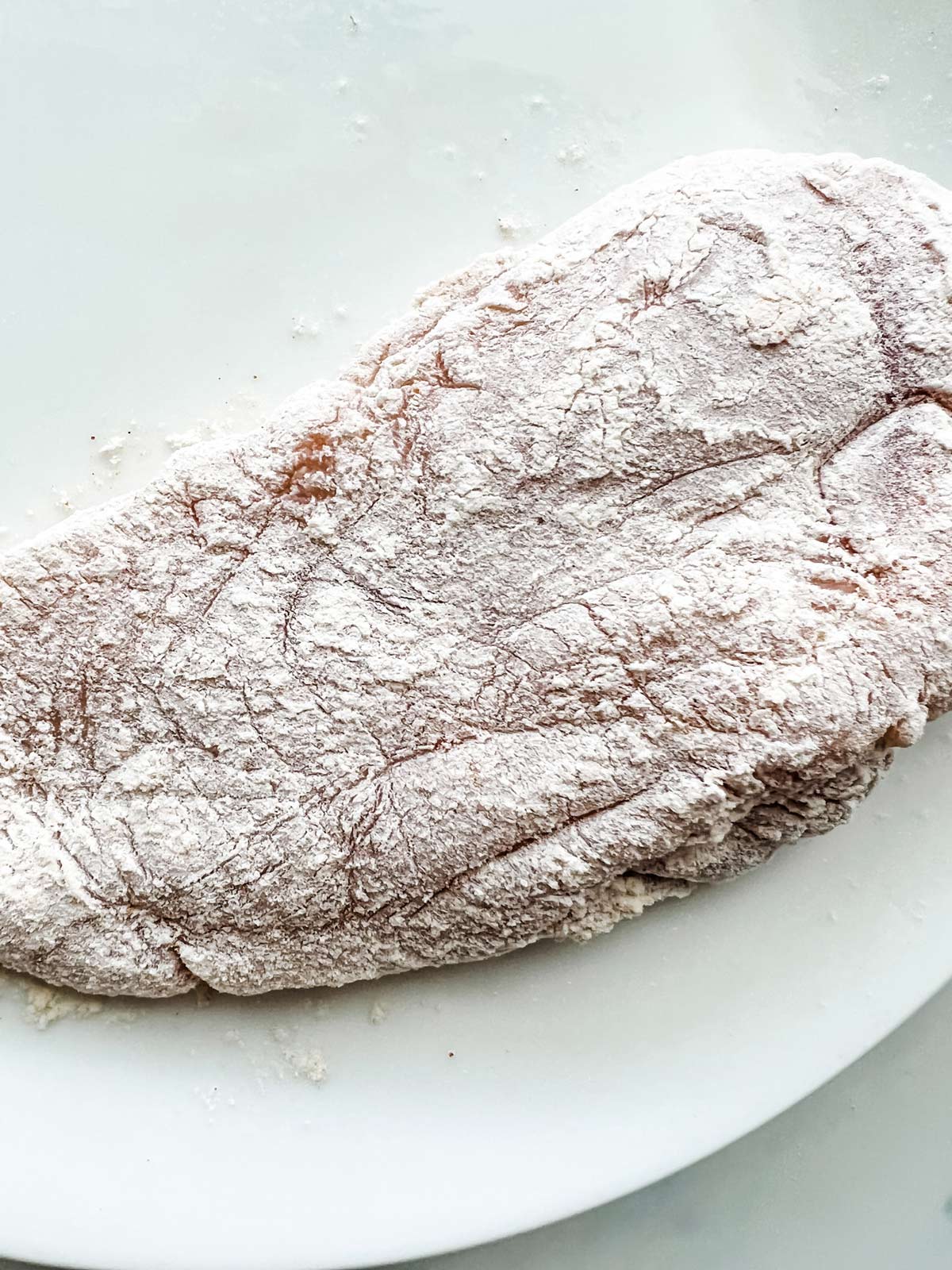 Chicken breast that has been dredged in flour.