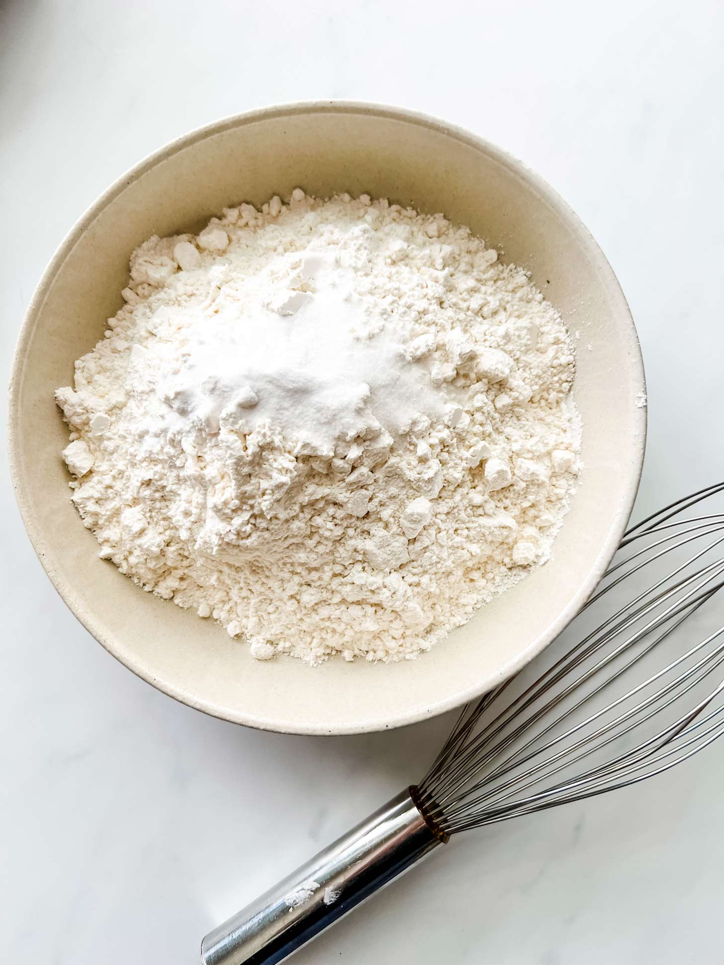 Photo of flour, baking soda, and salt in a medium bowl.