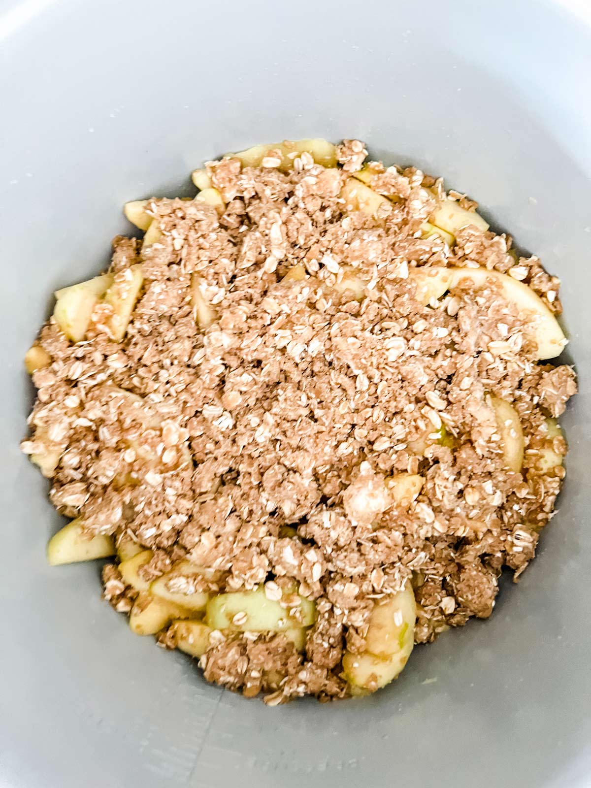 Sauteed apples with a crumble topping ready to cook in a Ninja Foodi.