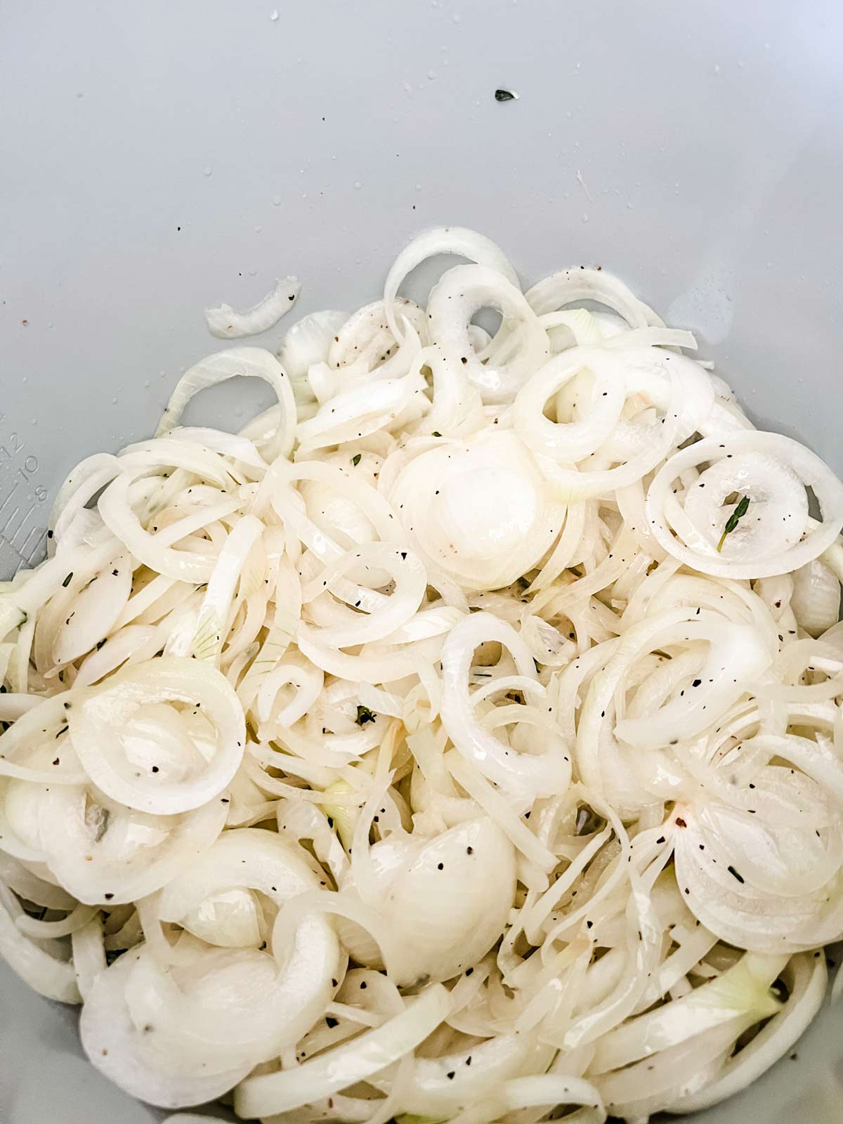 Onions and seasonings cooking in a Ninja Foodi.