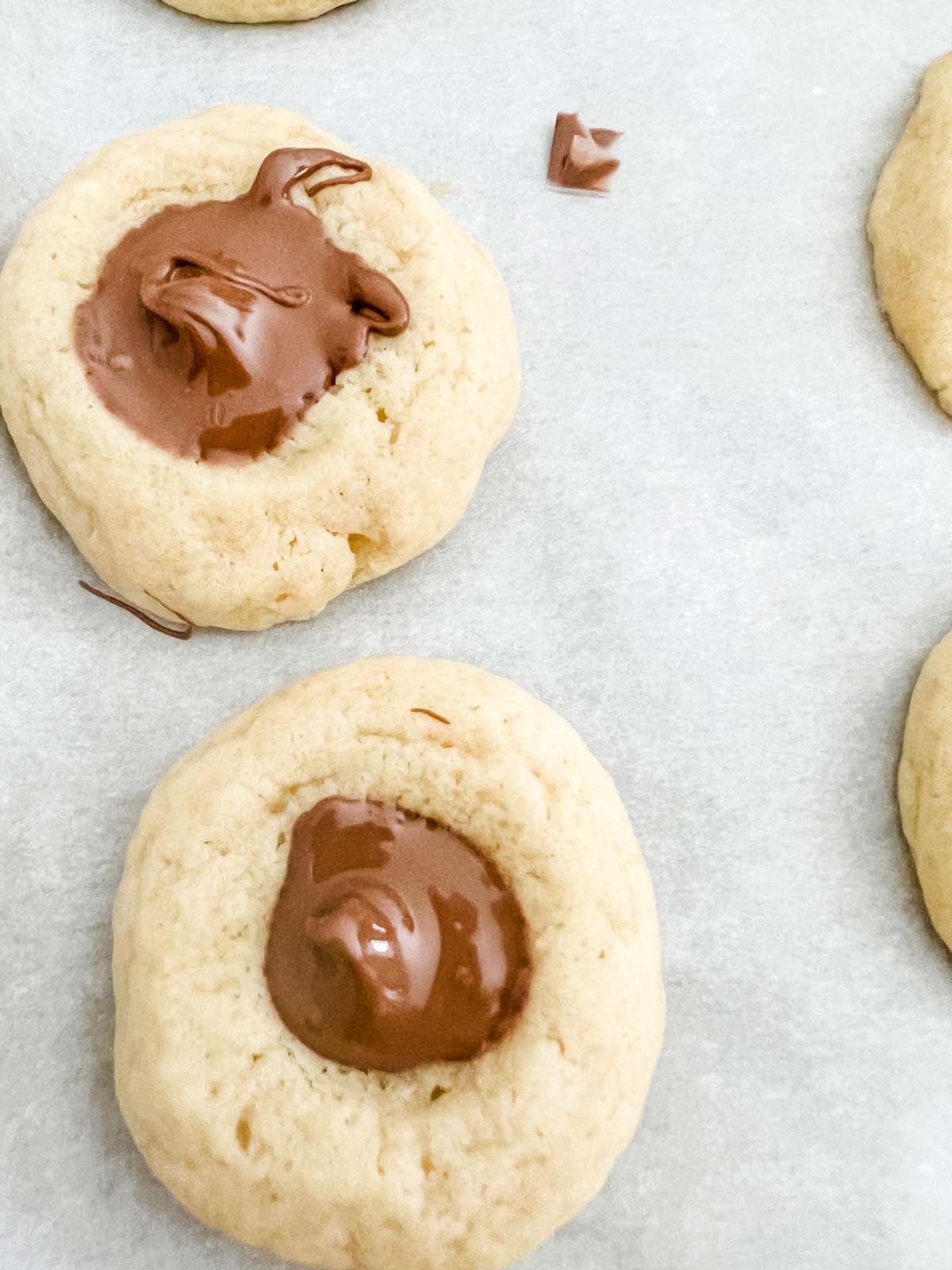 Nutella thumbprint cookies on a sheet pan.