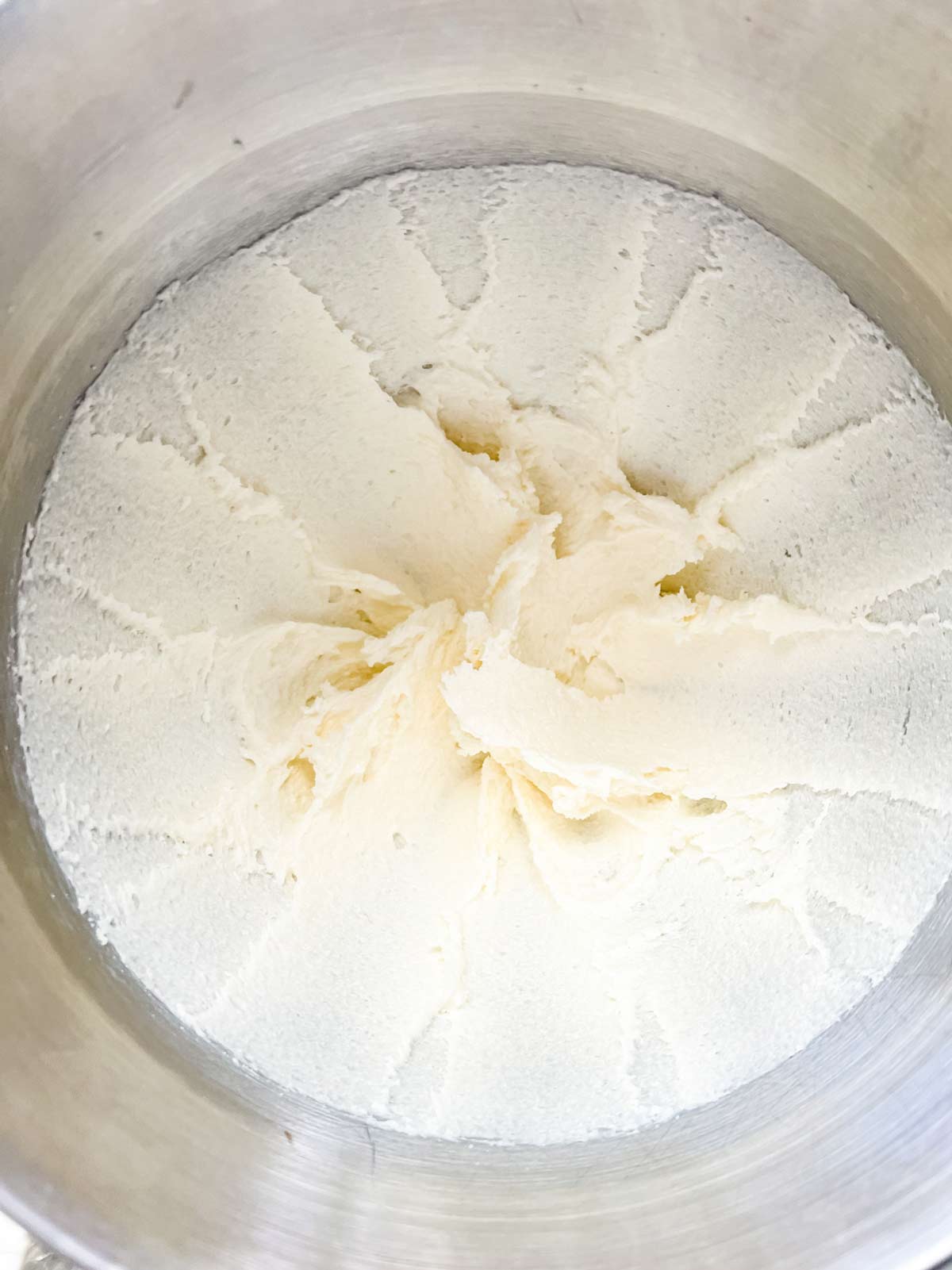 Butter and sugar creamed together in the bowl of a stand mixer.