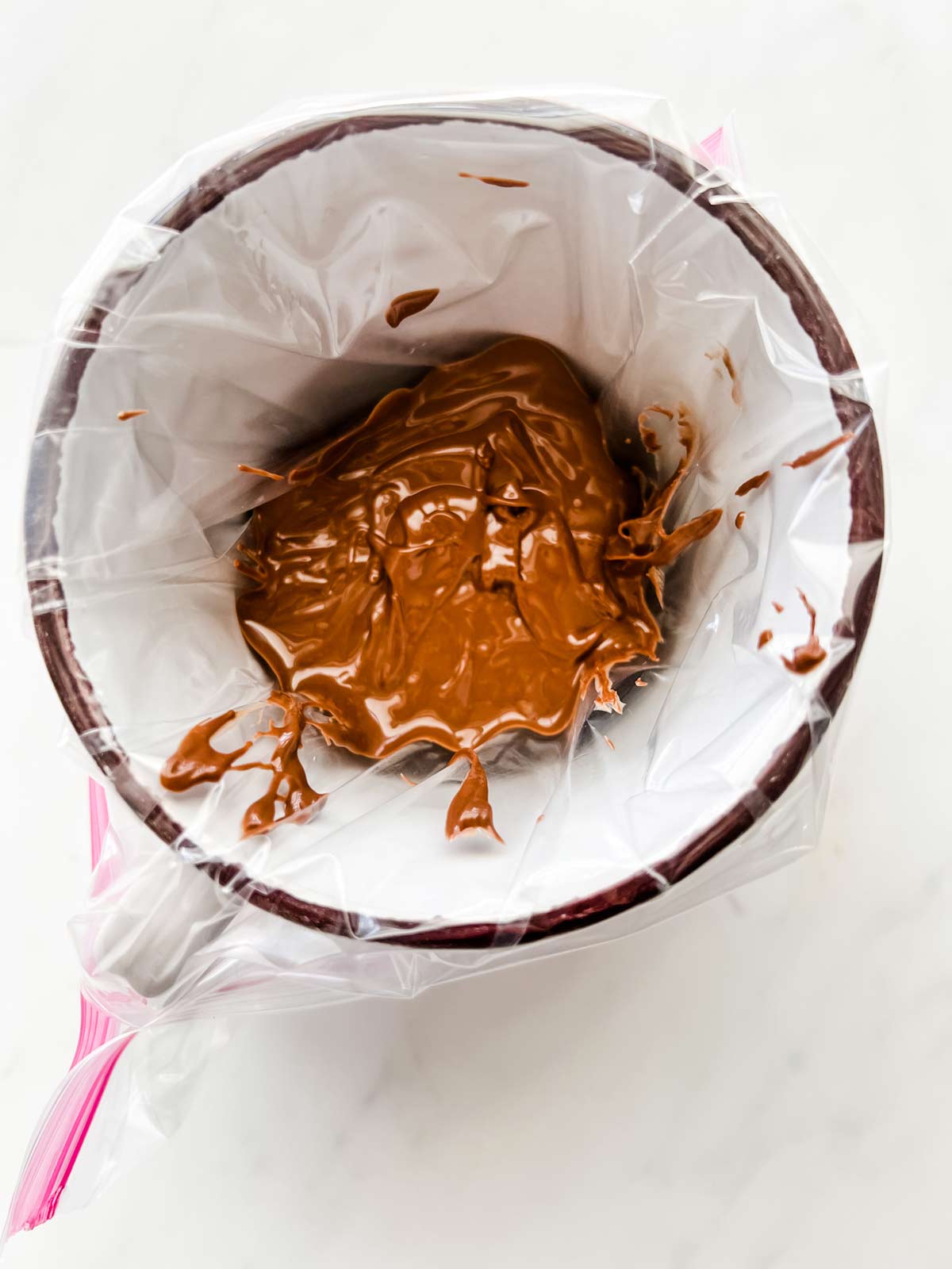 Warmed nutella in a bag ready for piping into cookies.