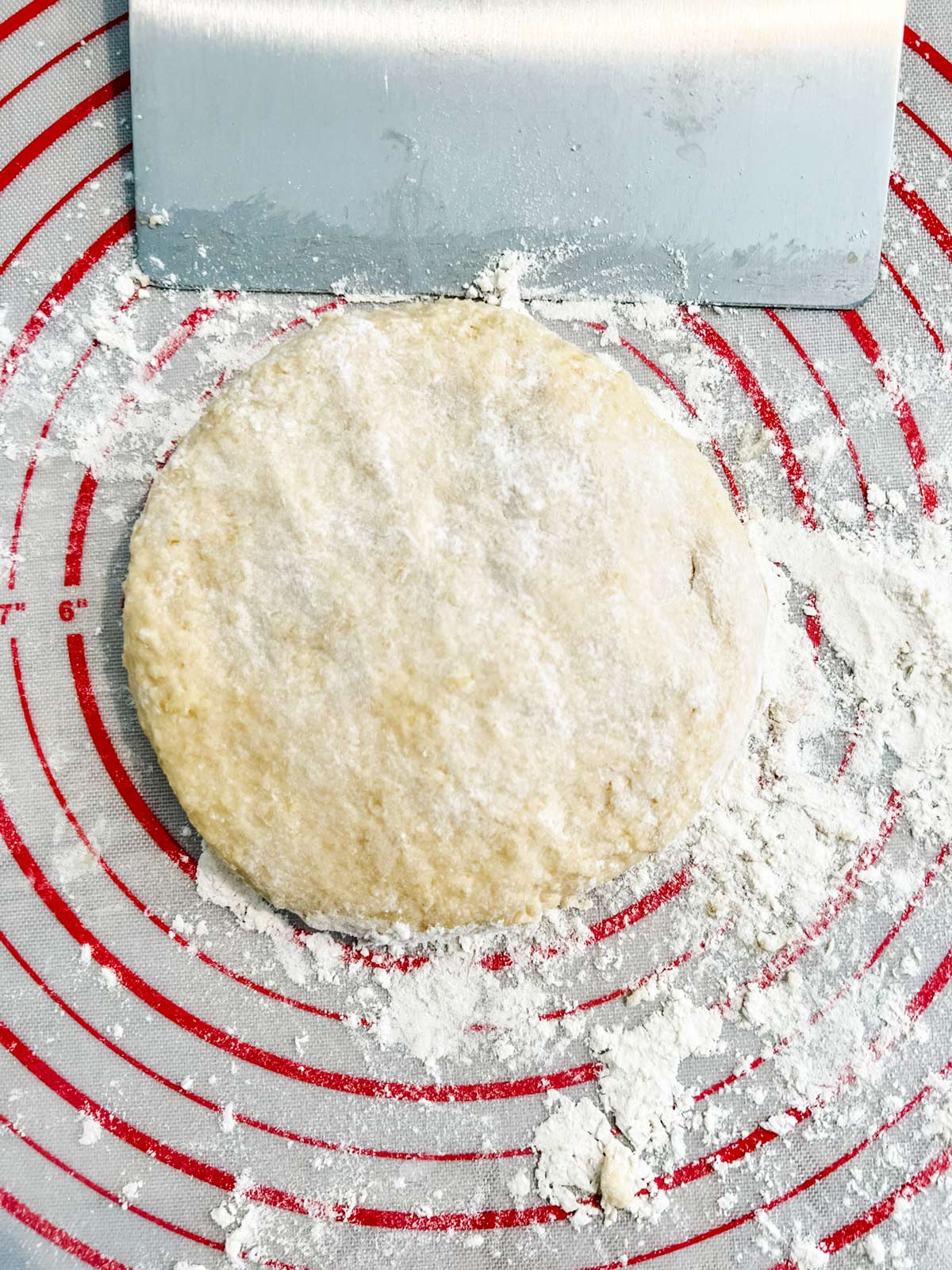 Brioche dough on a pastry mat sprinkled with flour.