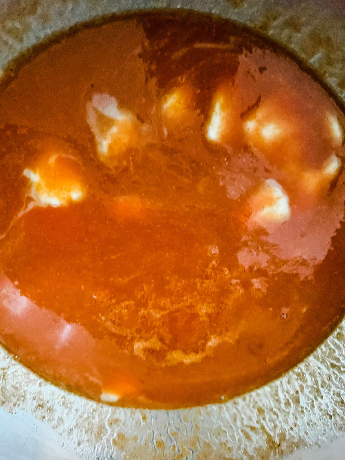 Photo of buffalo sauce cooking in a pan.
