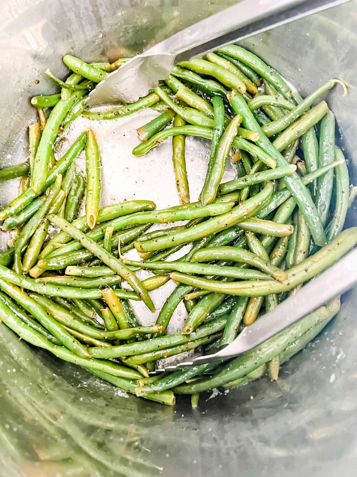Photo of green beans being finished in an inner pot of an Instant Pot.