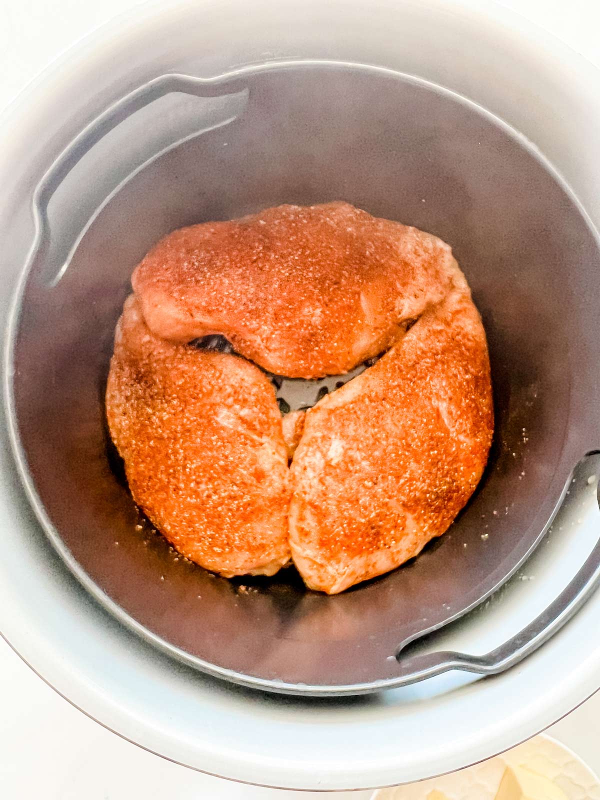 Chicken breast in the steam crisp basket of a Ninja Foodi.
