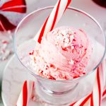Close up square photo of peppermint ice cream in a glass ice cream dish.