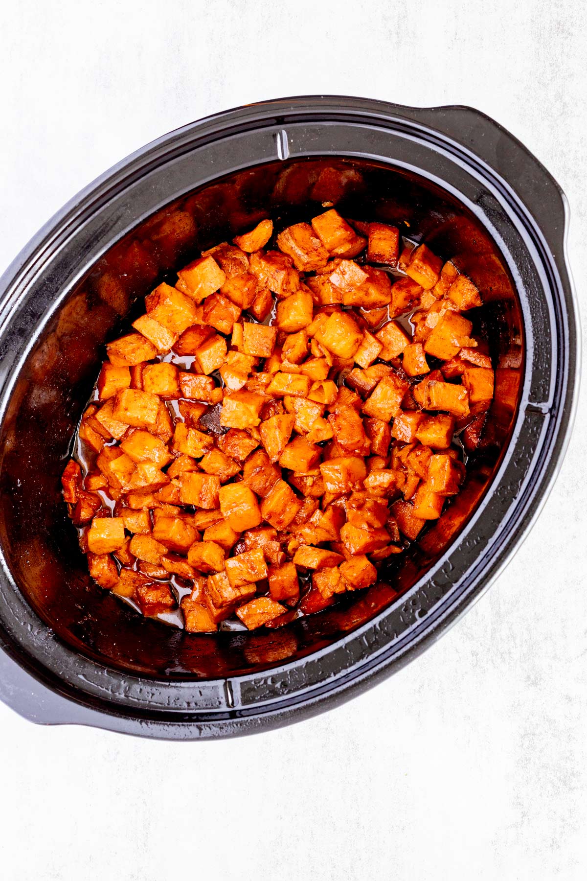 Sweet potato cubes that have been cooked in a slow cooker.