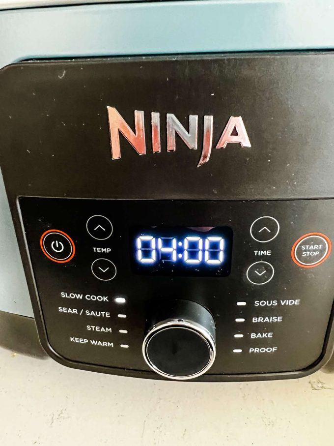 A Ninja Foodi possible cooker set to slow cook for 4 hours.