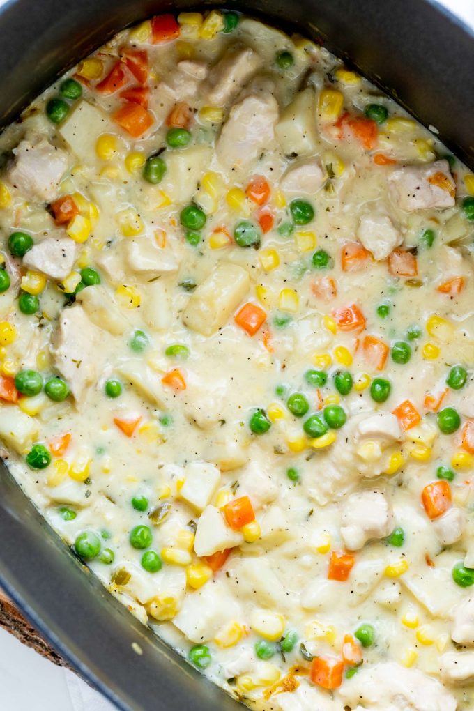 Close up photo of chicken pot pie filling in a slow cooker.