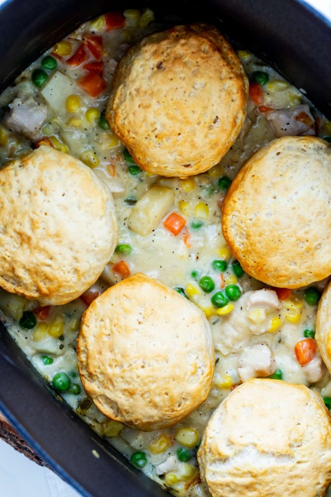 Crockpot chicken pot pie with biscuits in a slow cooker.
