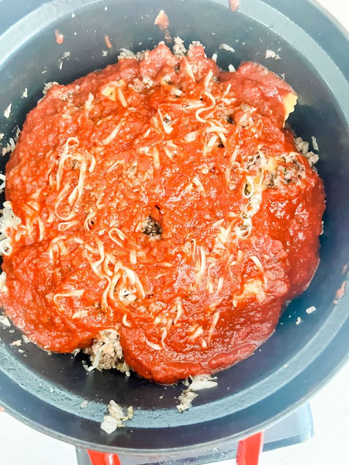 Crockpot ravioli lasagna in a slow cooker ready to cook.