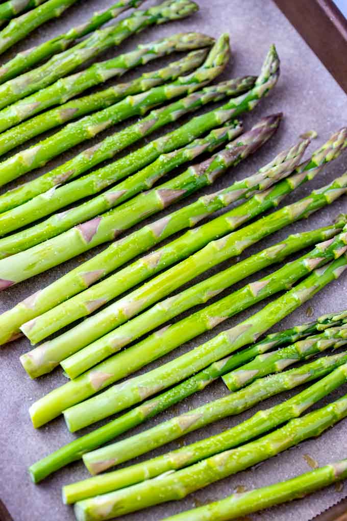 Photo of asparagus on a parchment lined sheet pan.