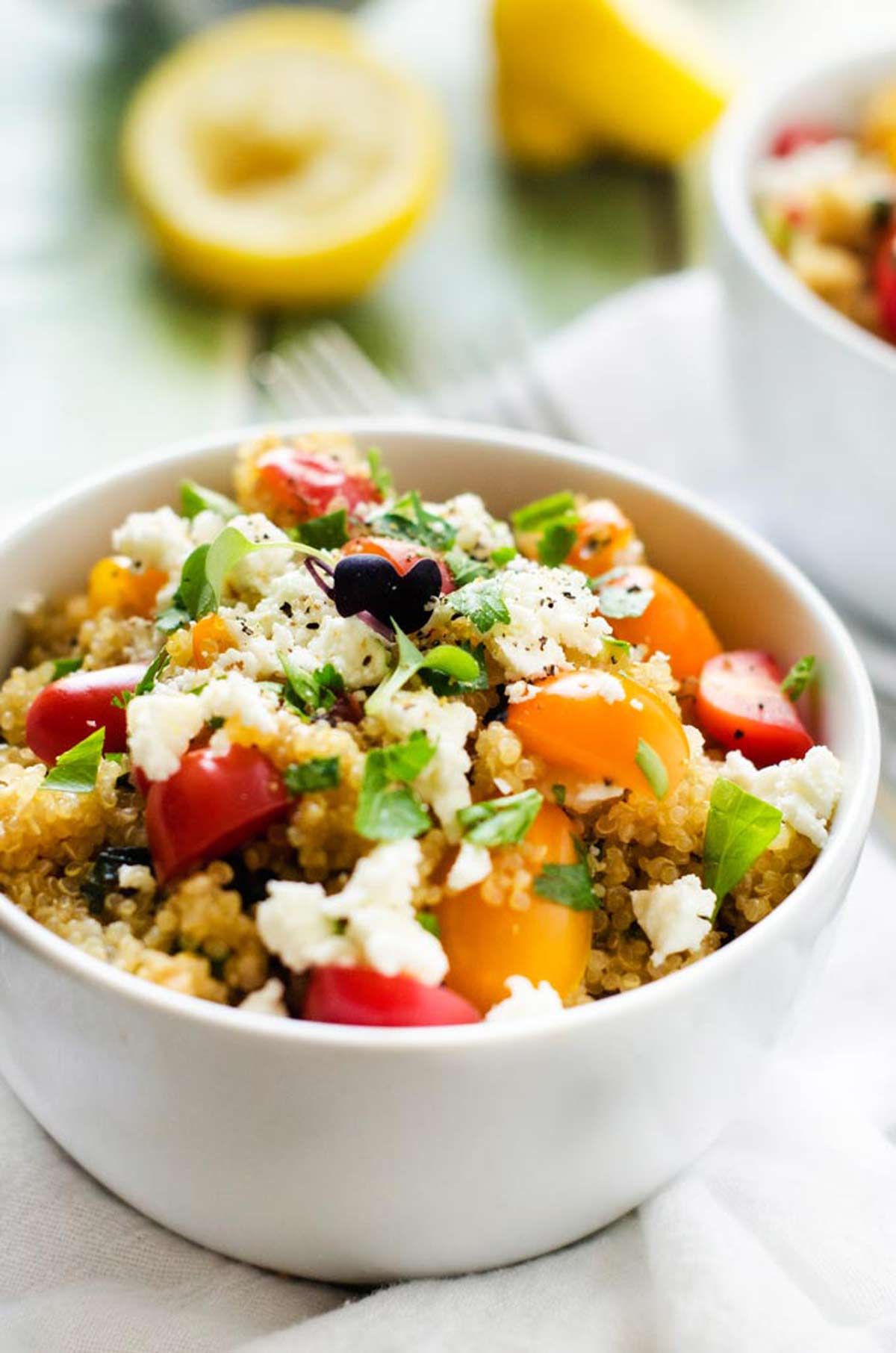 Side photo of a white bowl with quinoa pilaf in it.