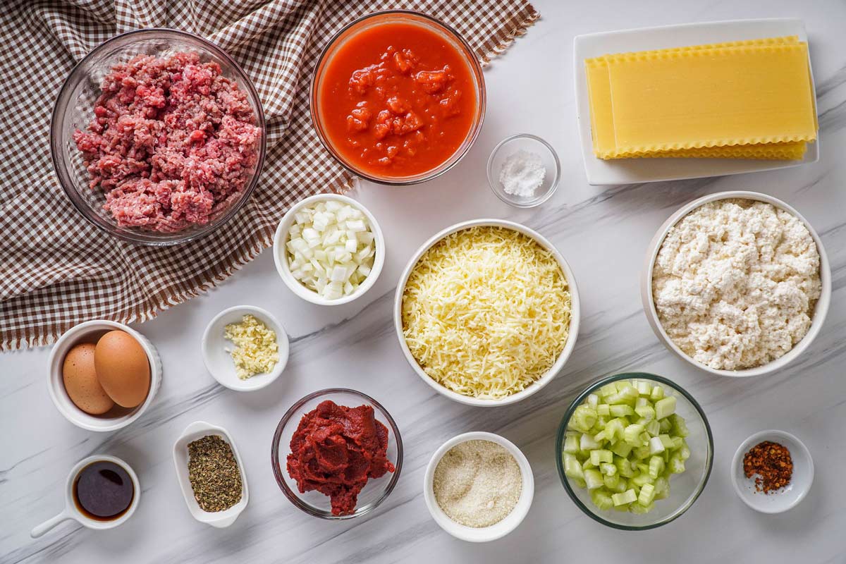 Overhead photo of lasagna ingredients in prep containers.