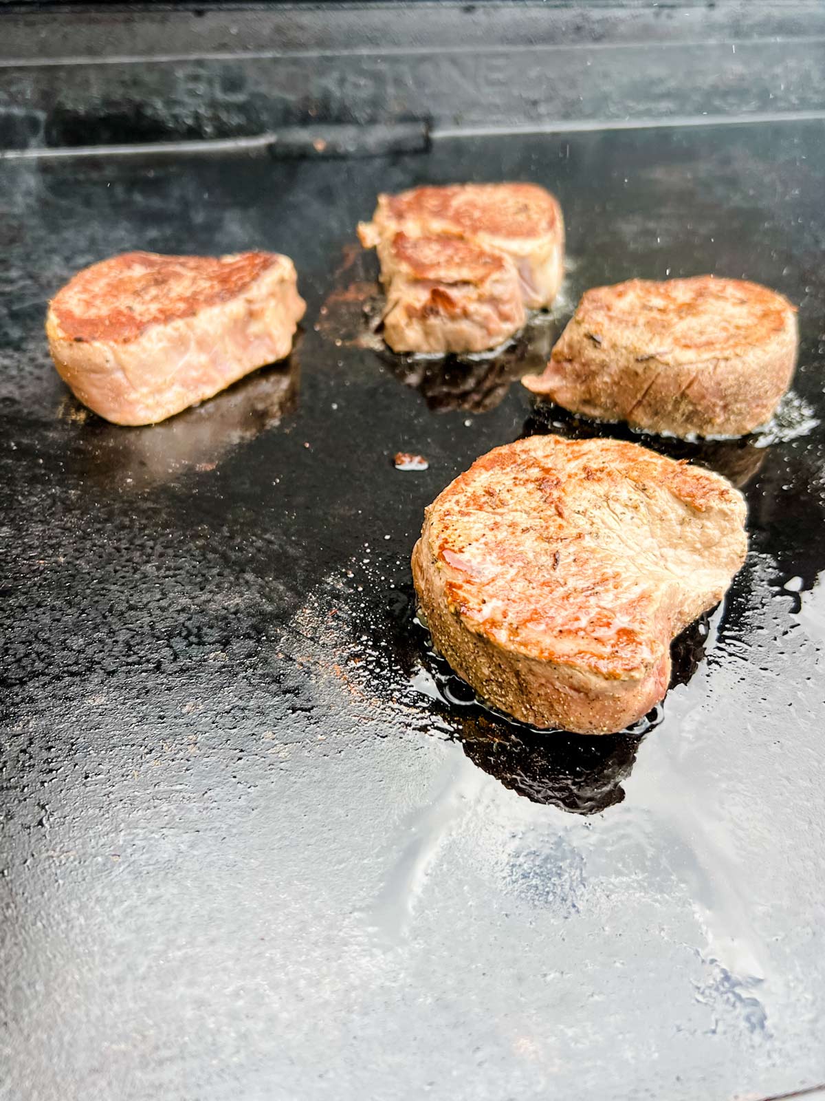 Filet mignon cooking on a Blackstone Griddle.