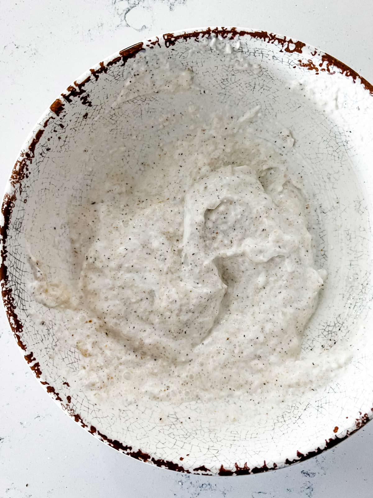 Horseradish cream in a rustic white bowl.
