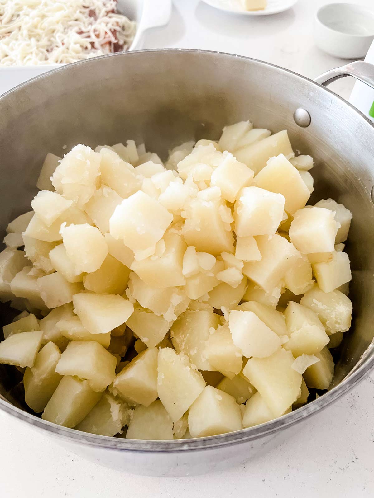 Cooked diced potatoes in a pot.