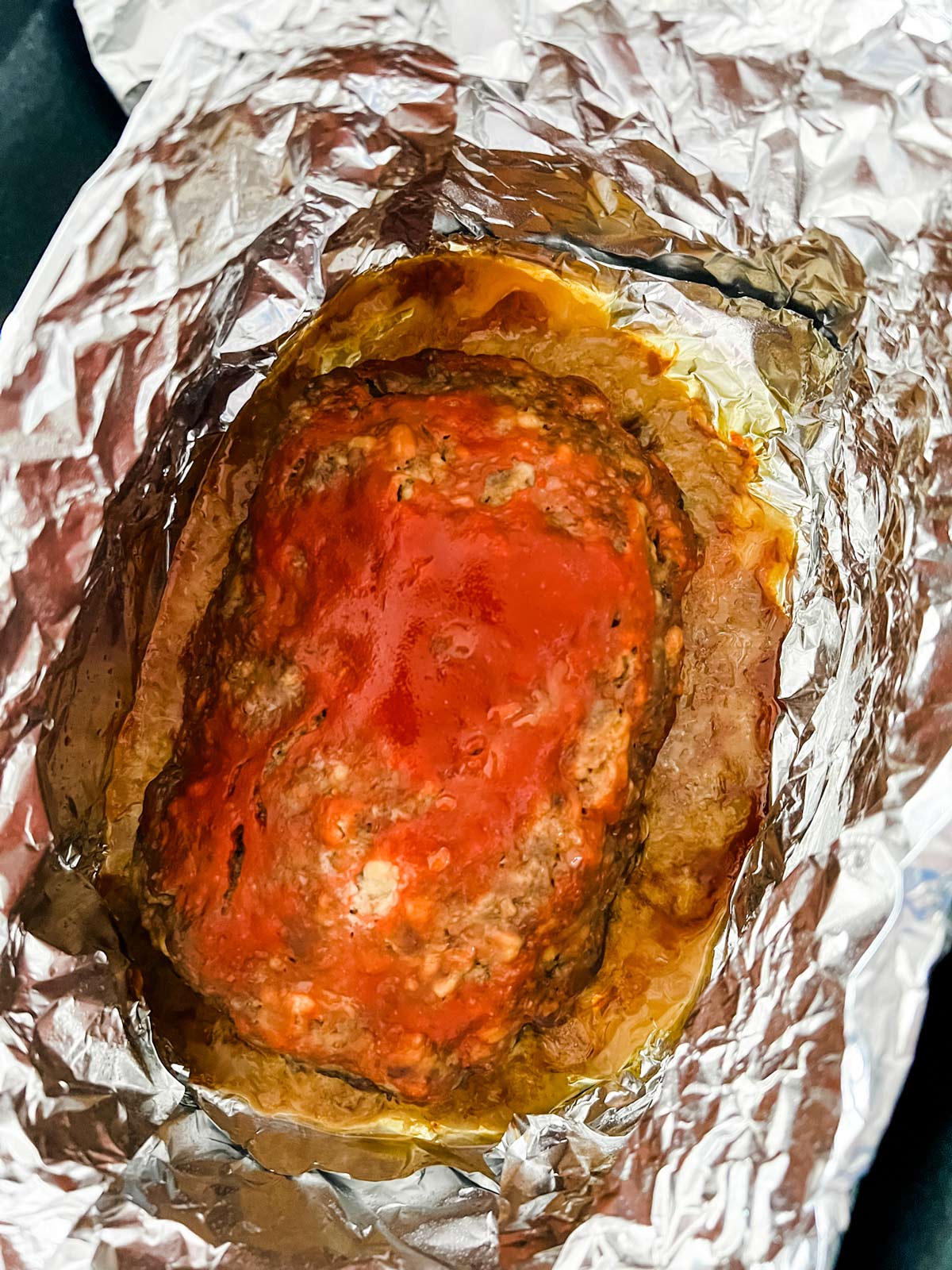 A glazed meatloaf that has cooked for six hours in a slow cooker.