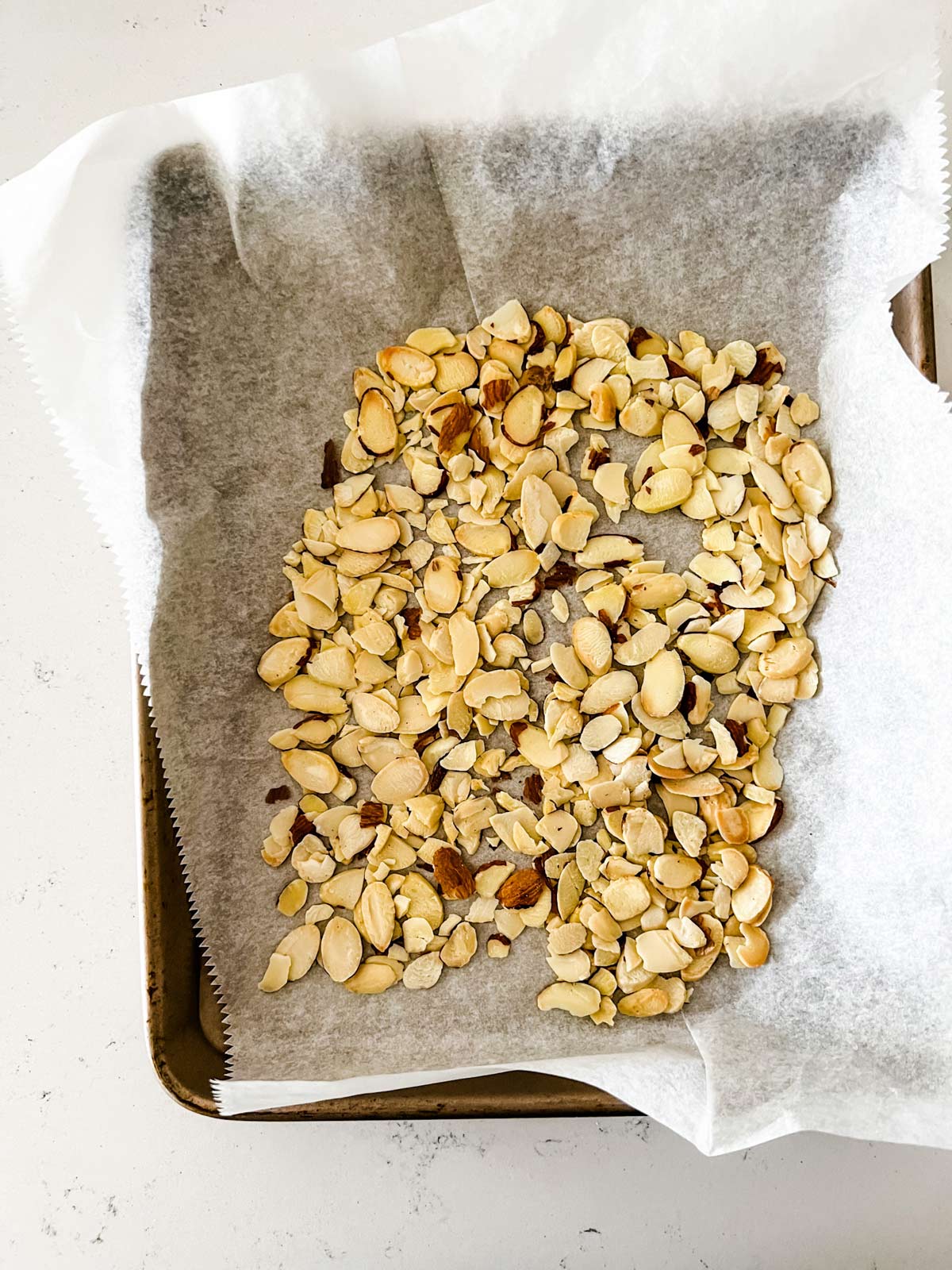Toasted almonds on a sheet pan.