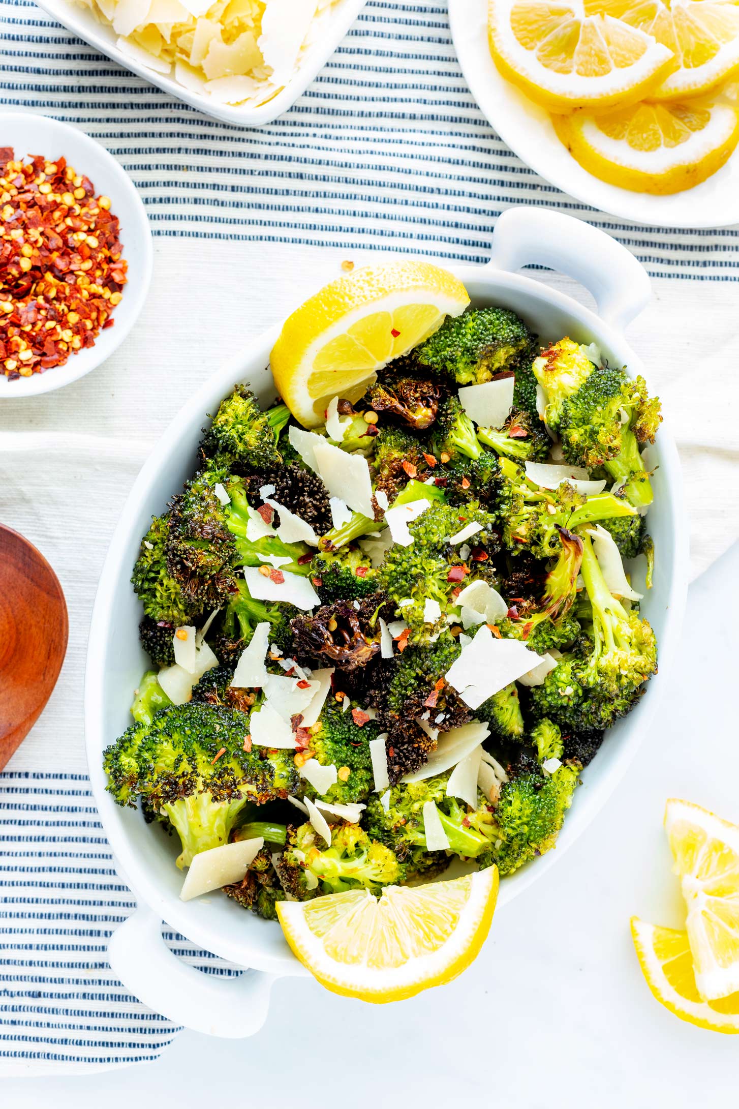 Overhead photo of a white serving platter with garlic roasted broccoli.