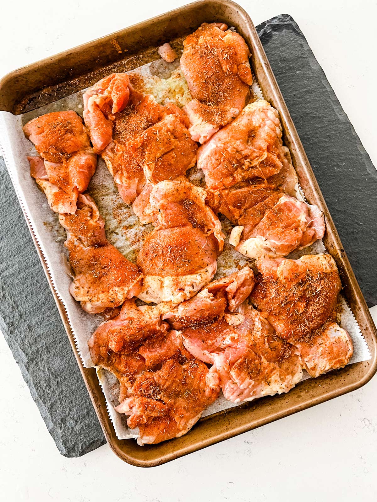 A tray of chicken thighs that have been seasoned overnight.