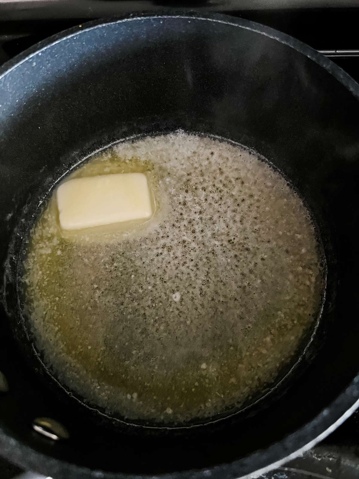 Butter melting in a small saucepan.