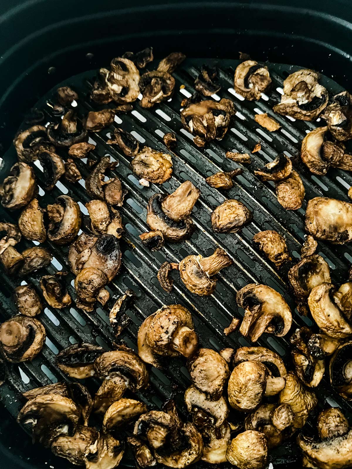 Cooked mushrooms in an air fryer.