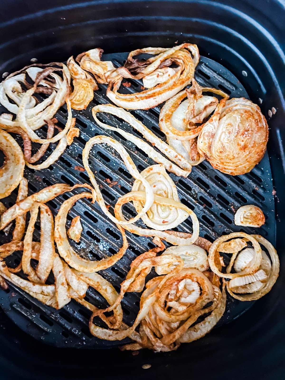 Cooked onions in an air fryer.