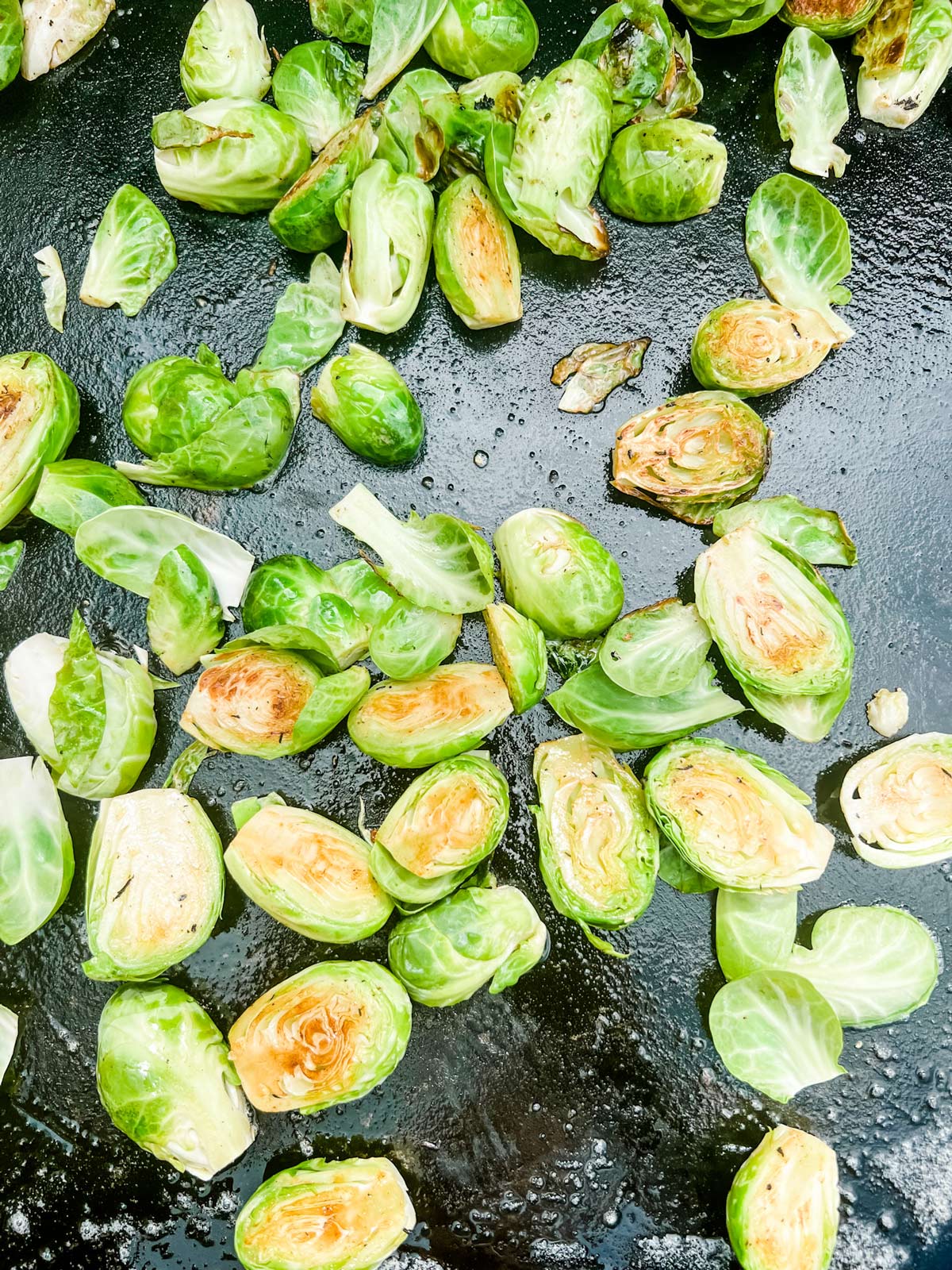 Brussels sprouts cooking on a Blackstone flattop griddle.