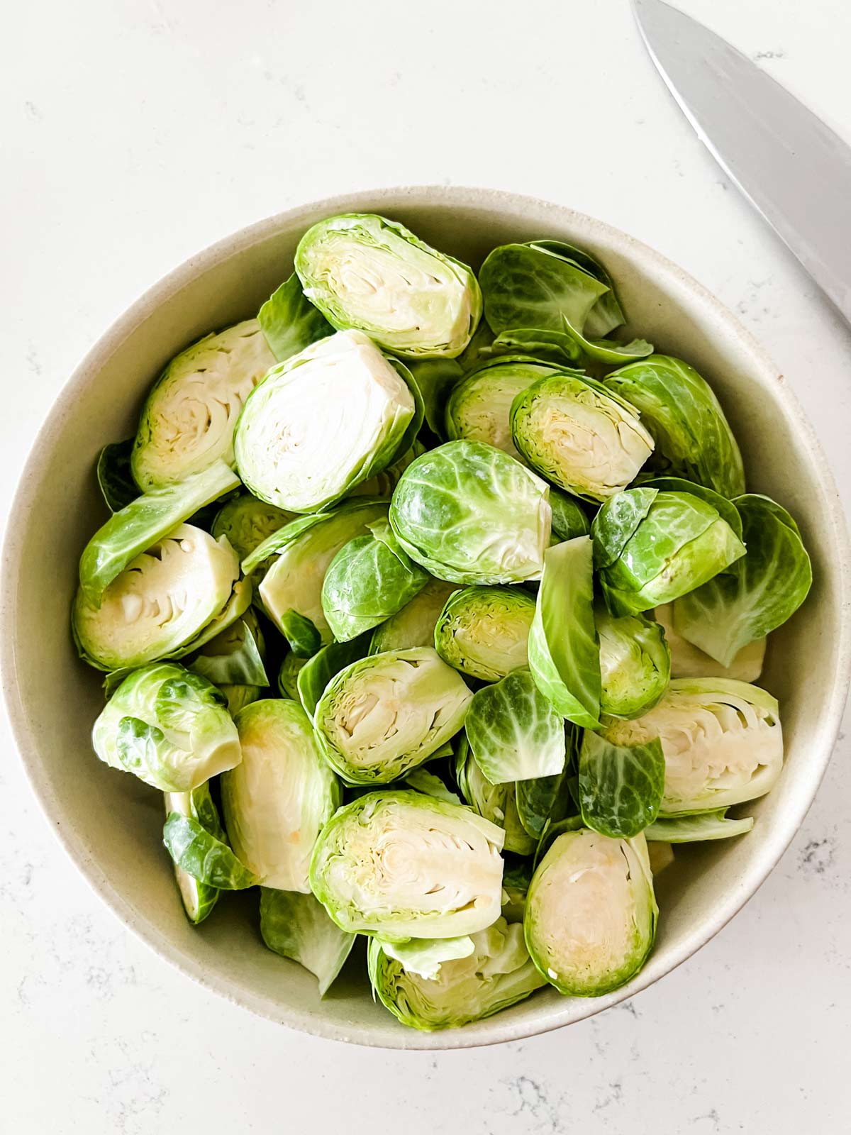 A bowl of trimmed Brussels sprouts.