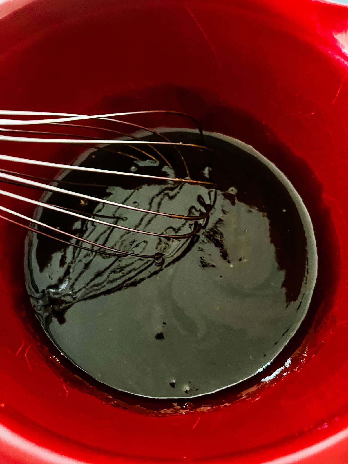 A BBQ sauce blend being whisked together.