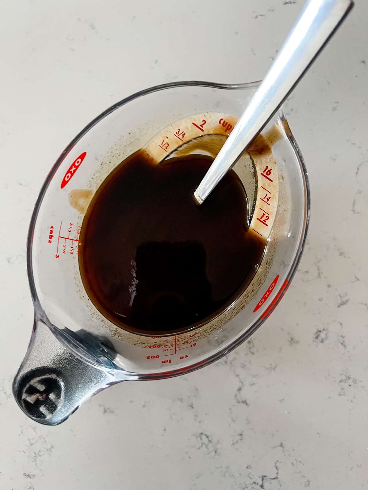 A BBQ sauce mixture in a measuring cup.
