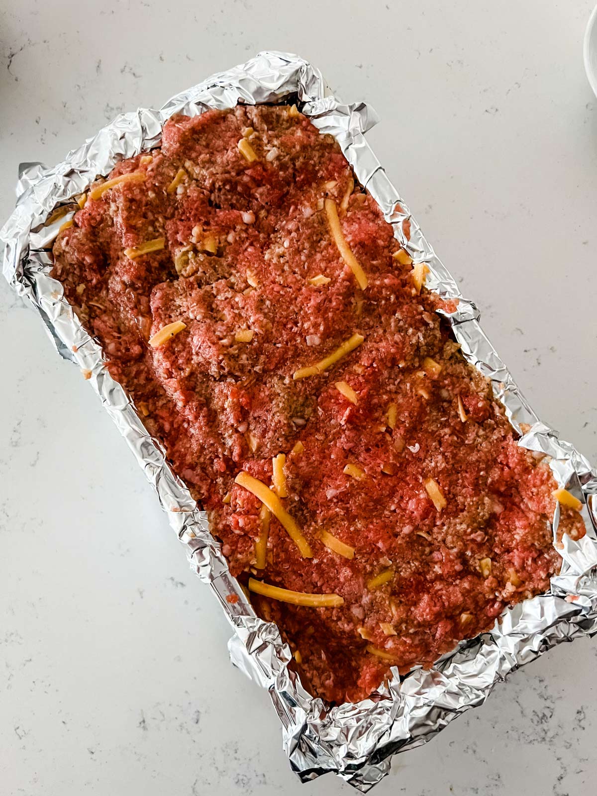 Meatloaf in a foil-lined bread pan.