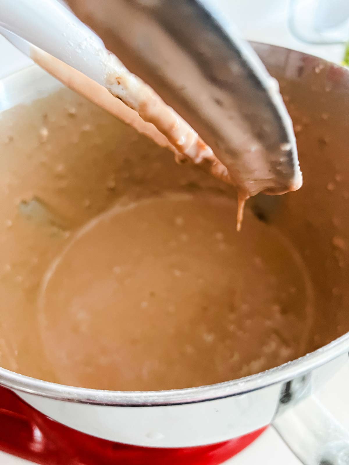 Nutella waffle batter in the bowl of a stand mixer.