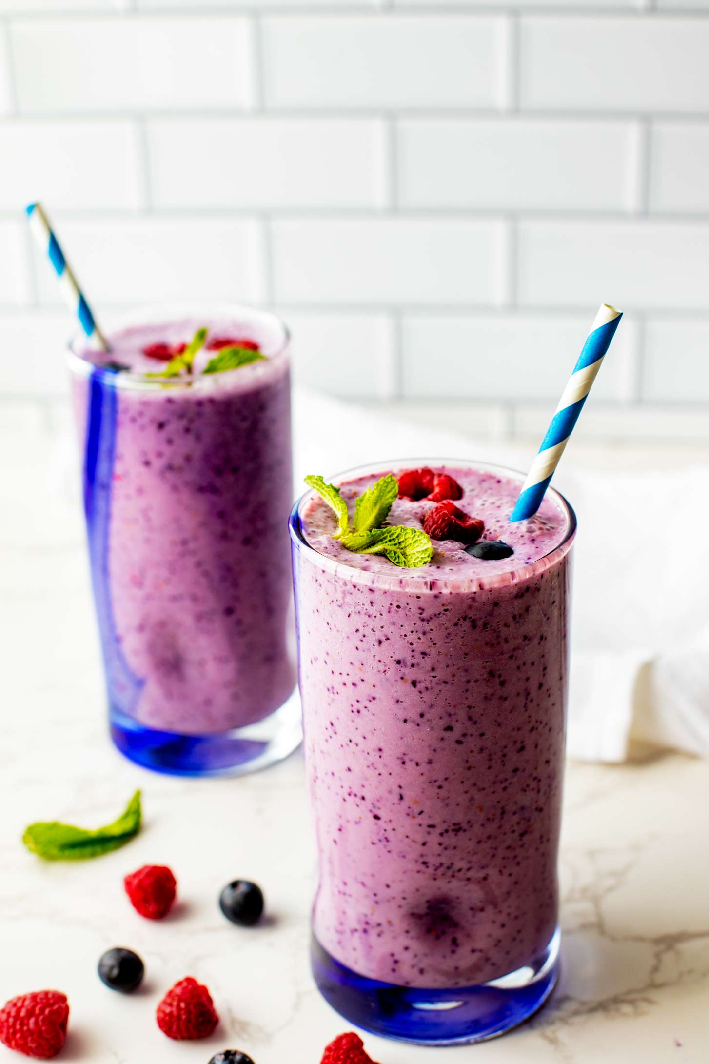 Side photo of raspberry blueberry smoothies ready to enjoy.