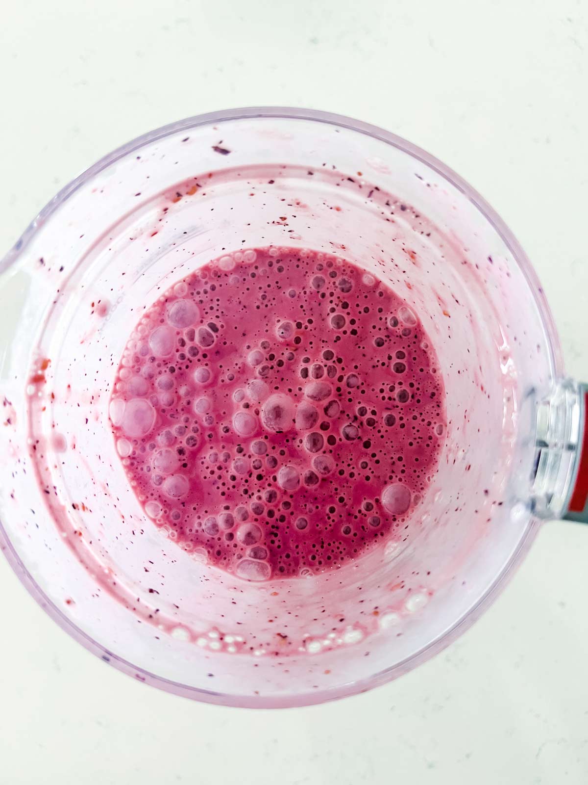 Raspberry blueberry smoothie in a blender.