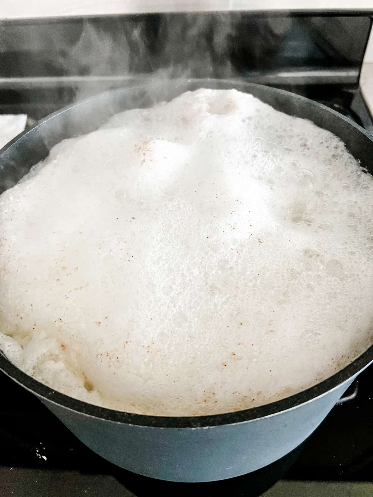 French fries boiling in a pot.