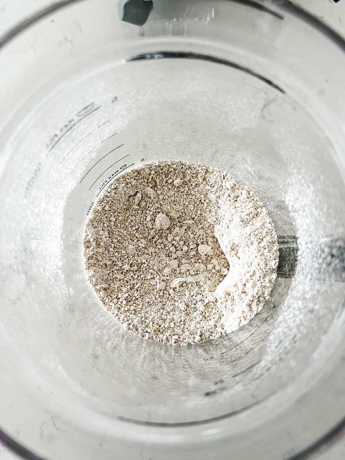 Ground oats that mimic oat flour in a blender.