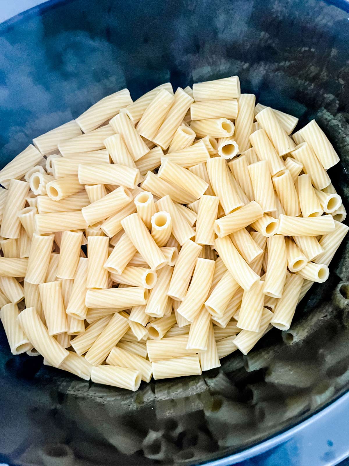 Partially cooked pasta in a slow cooker.