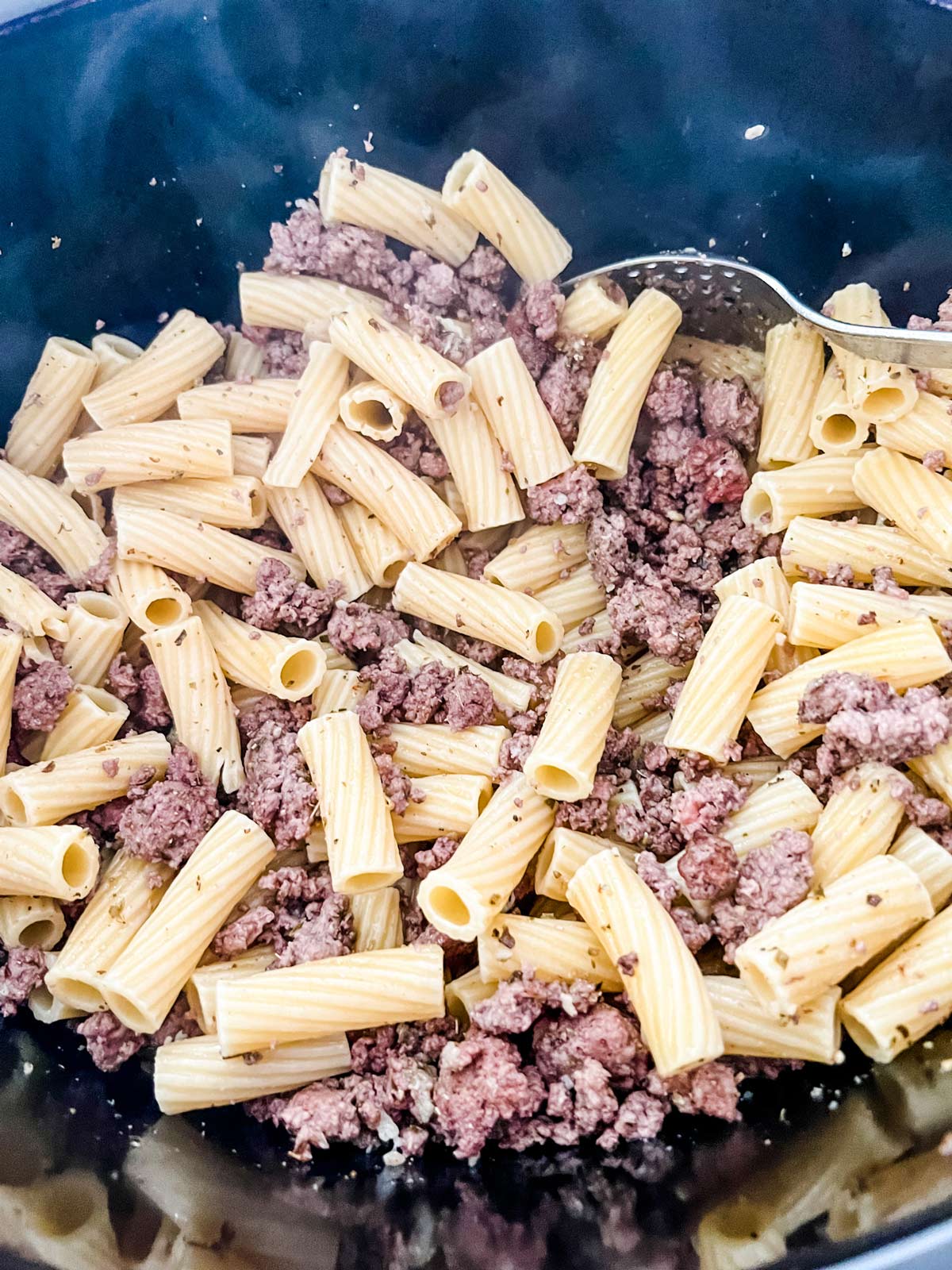 Ground beef and pasta stirred together in a slow cooker.