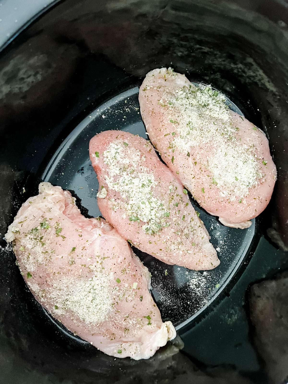 Ranch seasoning chicken breast in a crockpot.
