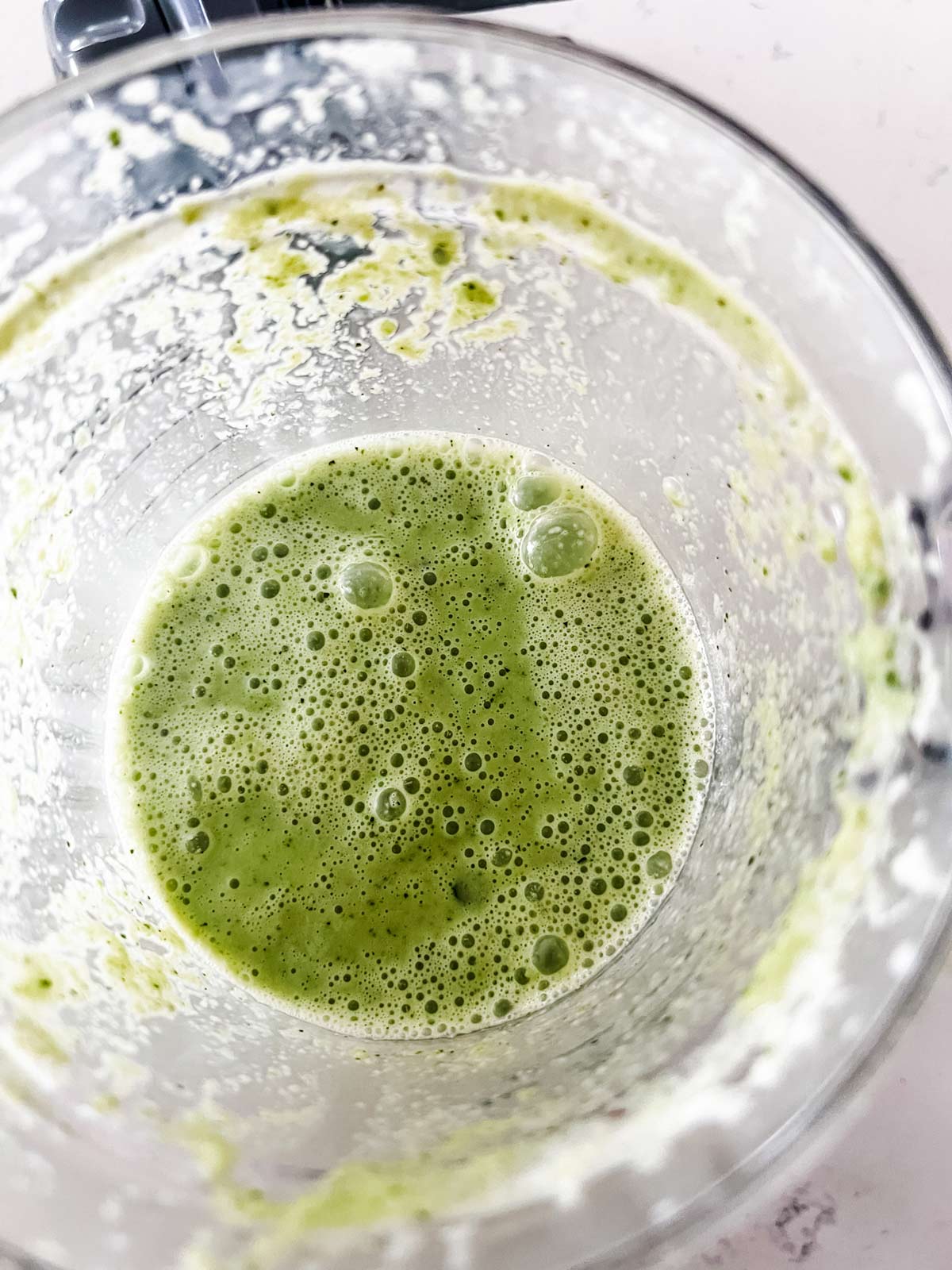 A cucumber apple smoothie in a blender.