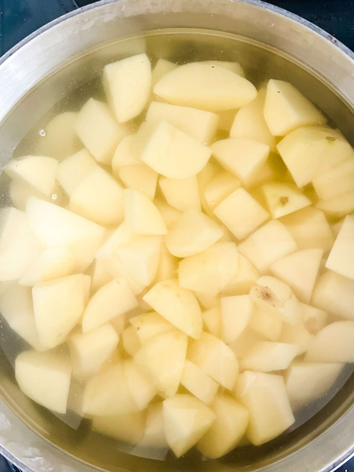 Diced potatoes being brought to a boil.